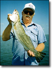 Captain Red Childers with his water body record speckled trout.