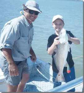Captain Tony and young man with 28" Red Fish